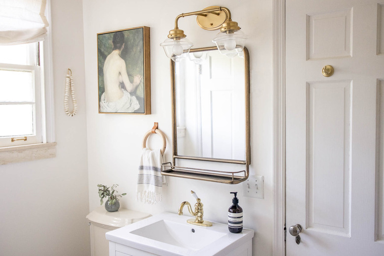 Bathroom with brass light and mirror
