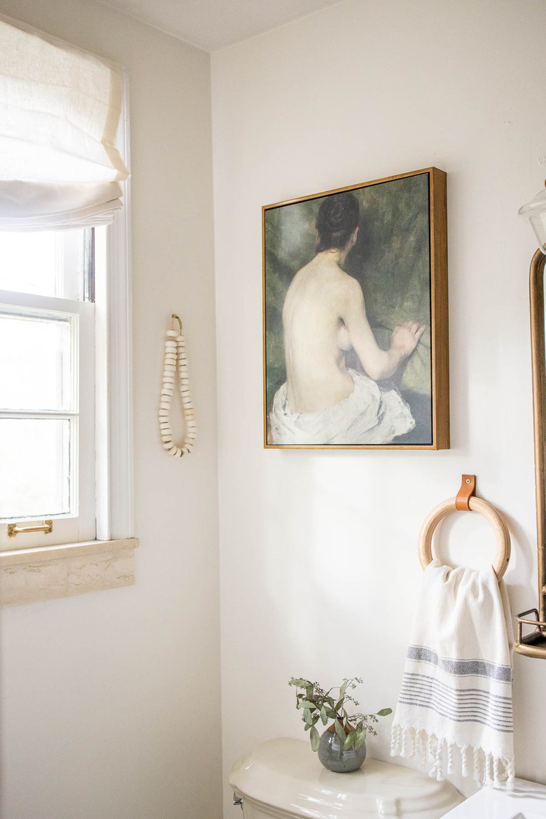 vintage oil painting on canvas hun in bathroom with wooden towel ring and bone beads