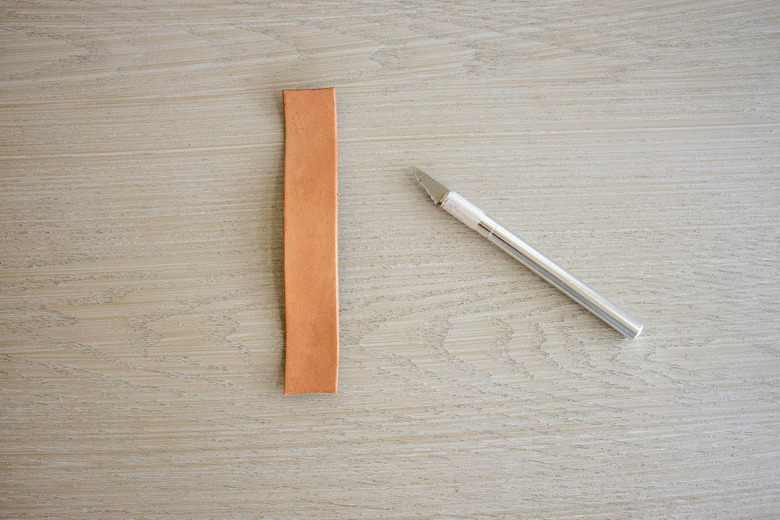 Leather strap cut into 8-inch length with utility knife