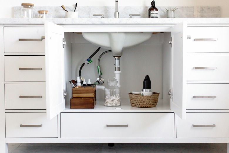 white bathroom vanity with doors open
