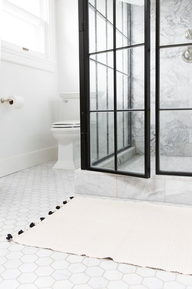 bathroom rug idea in white and black bathroom with hexagonal floor tile