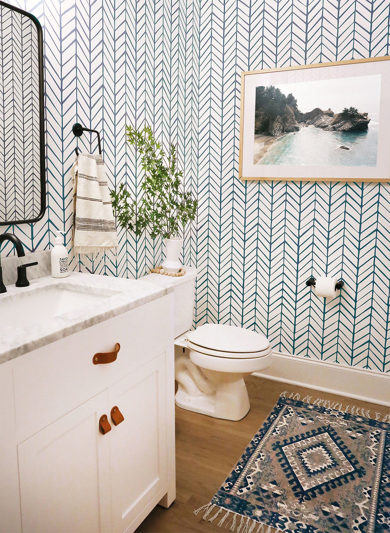 bathroom rug idea with patterned wall paper and wood flooring