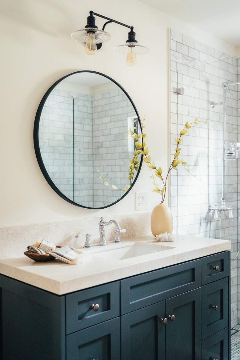 Bathroom with blue painted cabinets