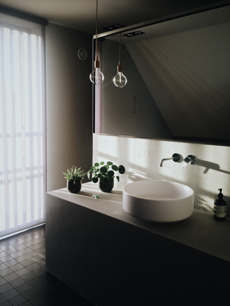 bathroom vanity lighting ideas with plug-in pendant and Edison bulb over minimal white sink
