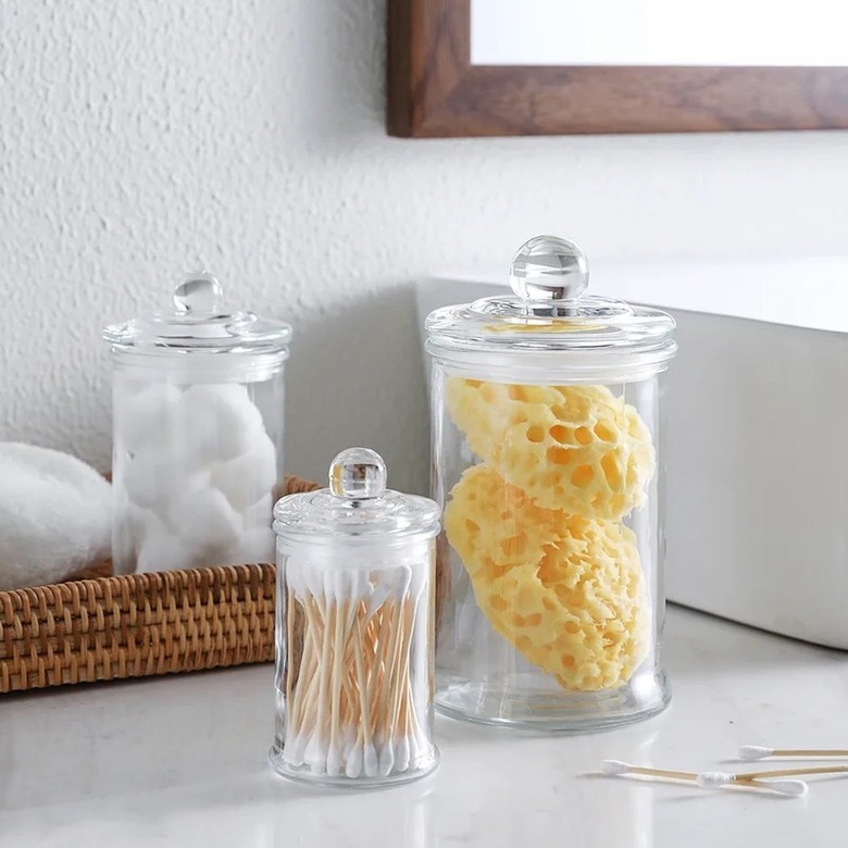 clear apothecary jars filled with toiletries