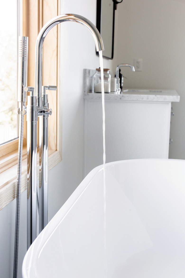 running high-arc faucet and stand-alone tub