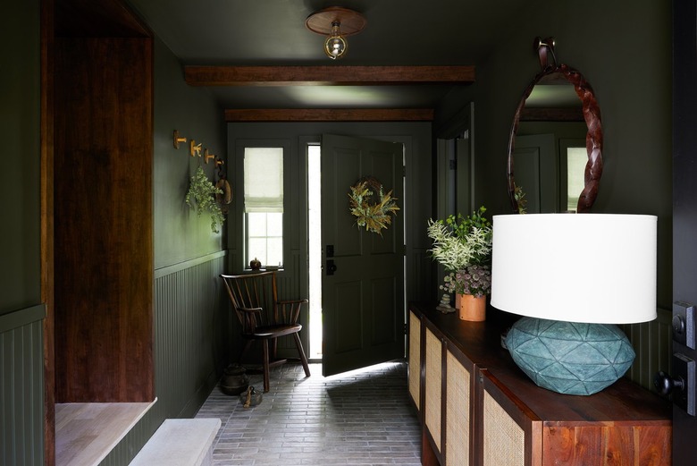 dark green mud room with door slightly open