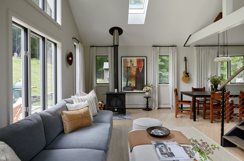 The living and dining area of designer Becky Shea's home featuring a couch and dining area nearby