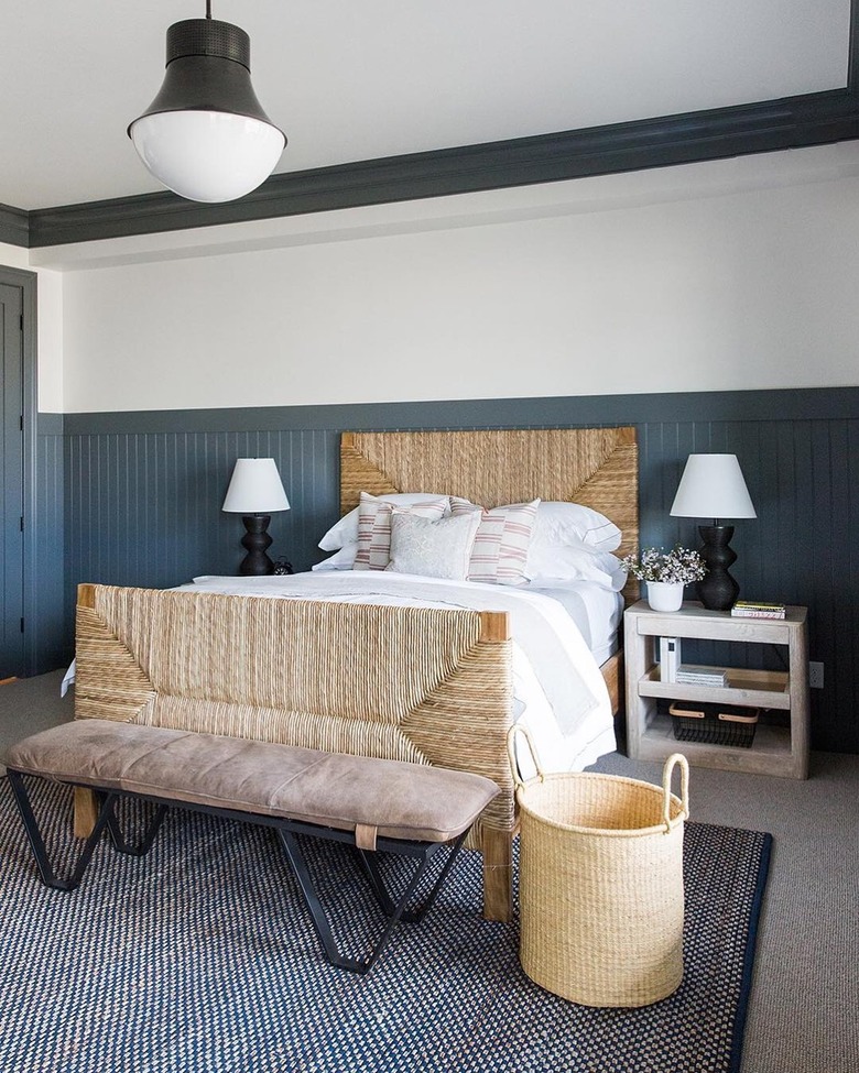 Grey Owl paintd panel walls and rattan bed with white bedding