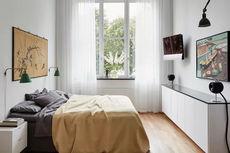 Light gray bedroom with a yellow bedspread on top of gray sheets