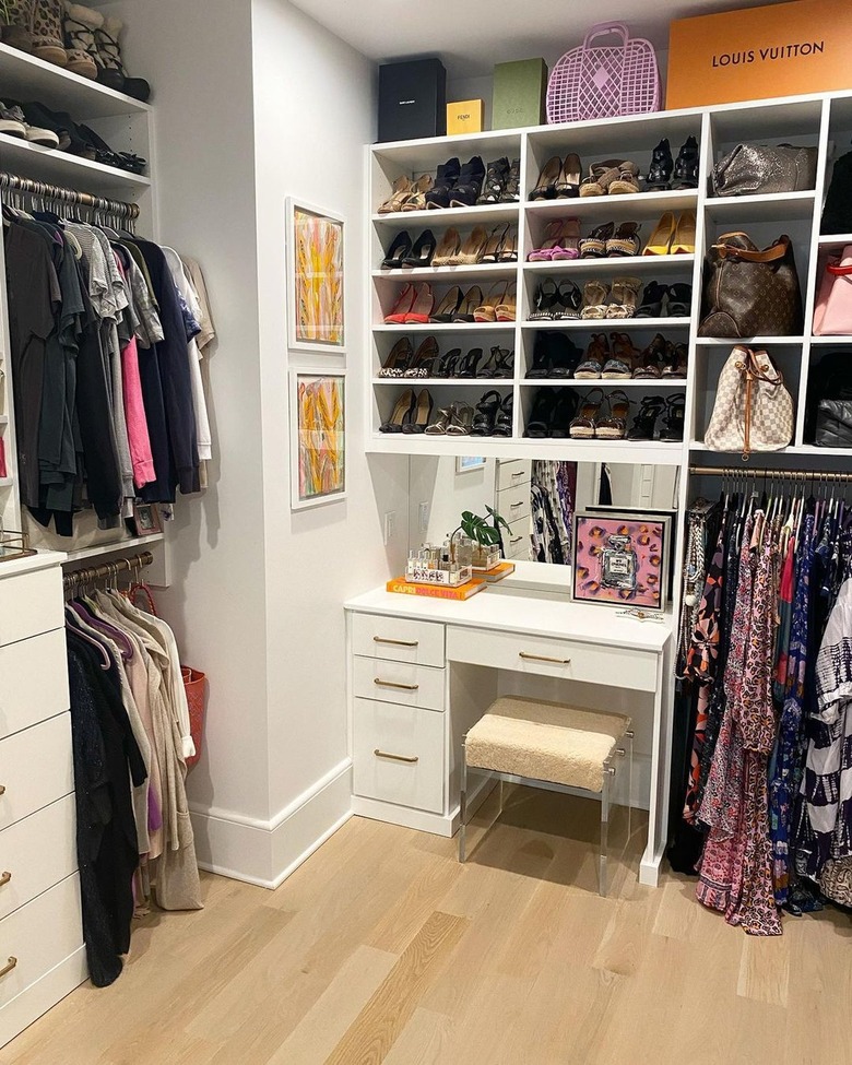 Walk-in closet with white cabinetry