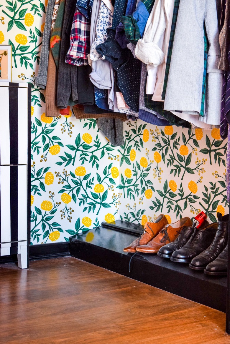 Closet floor with yellow and green floral wallpaper