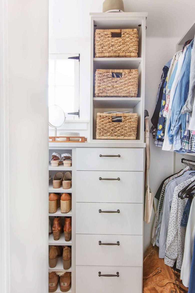 Walk-in closet designed by Emily Henderson with white cabinetry