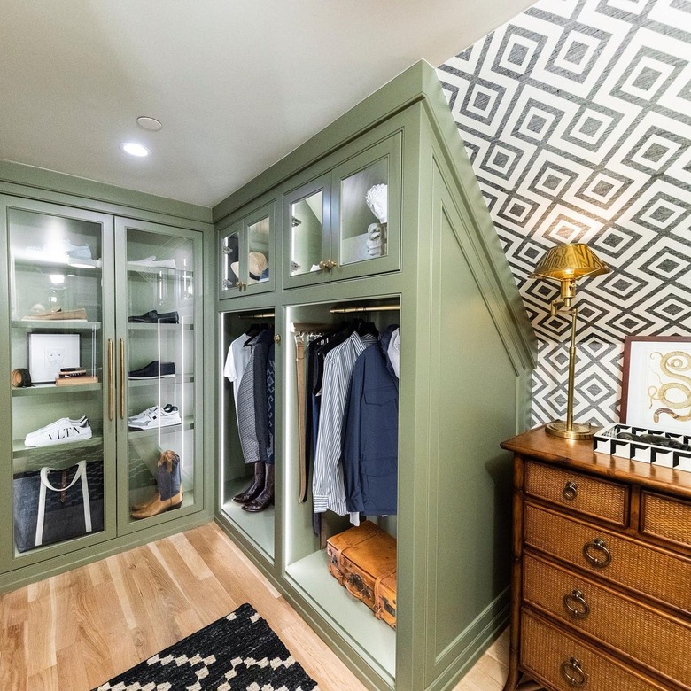 Walk-in closet with green cabinetry