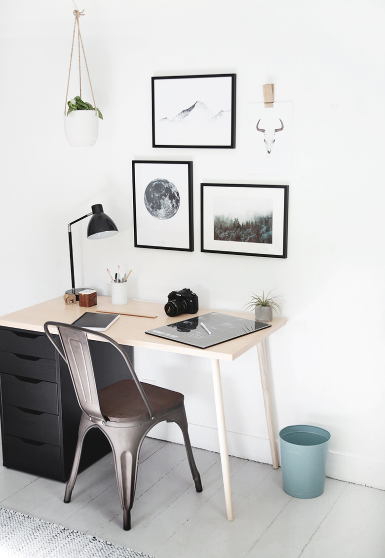 Bedroom desk with minimal decor and black and white wall art