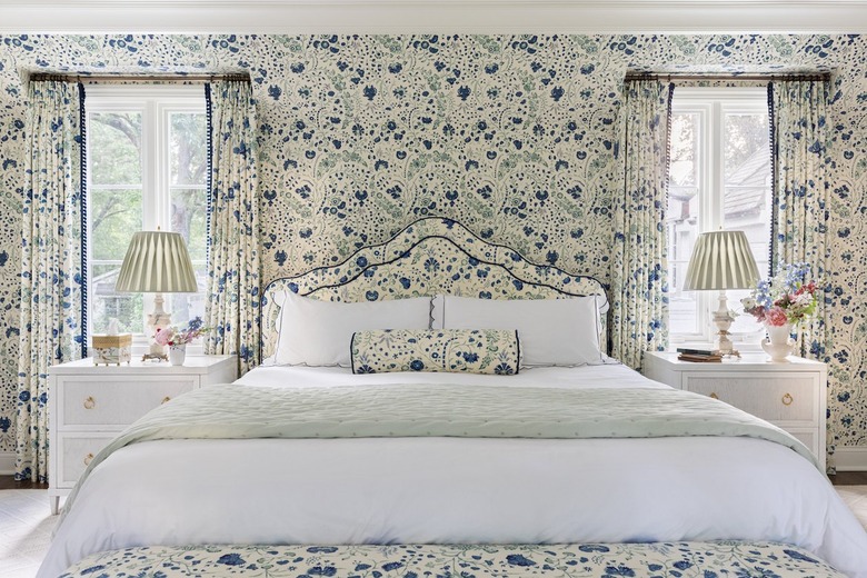 Maximalist granny chic bedroom with cornflower blue floral print wallpaper