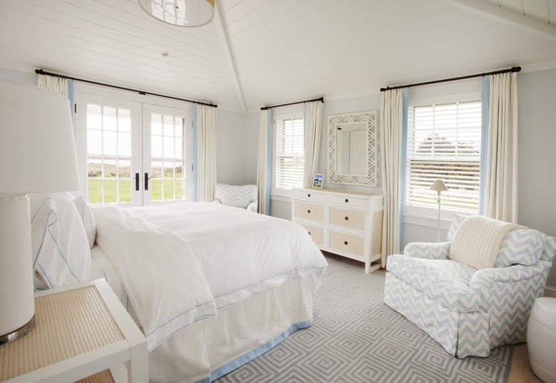 White and blue bedroom with vaulted ceiling