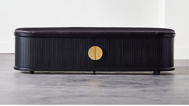 black bedroom storage bench with cushioned top and brass pulls