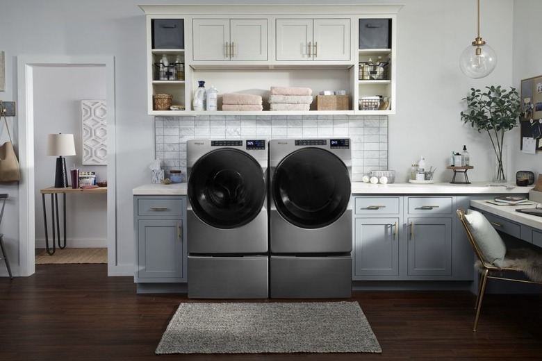 Whirlpool silver front-load washer and dryers in a laundry room