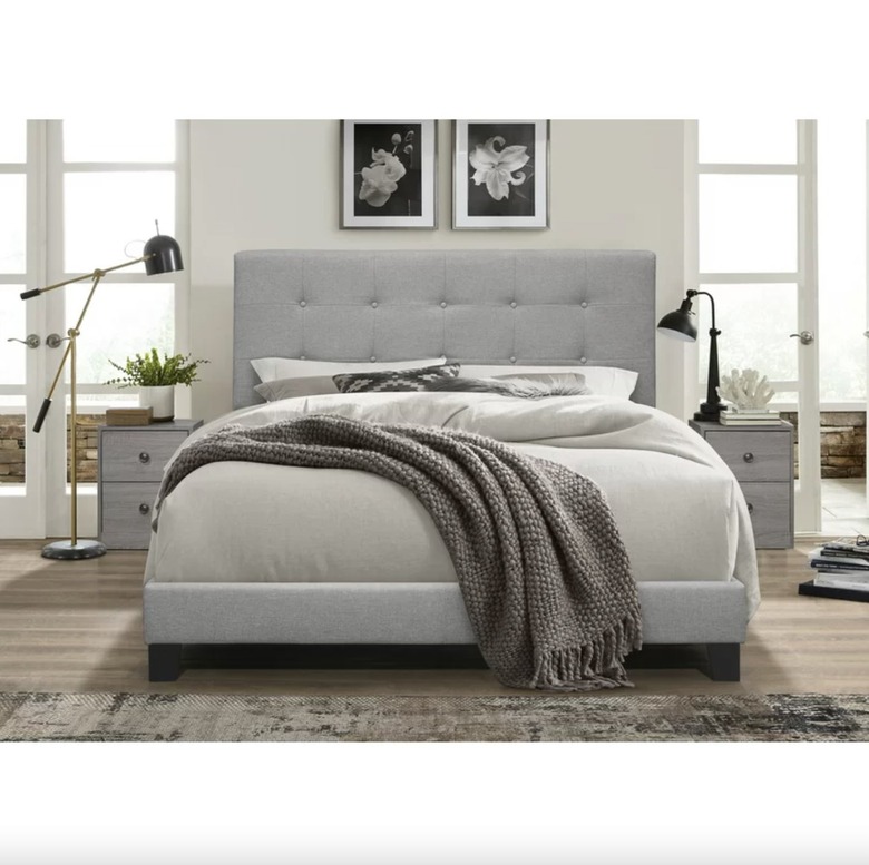 gray upholstered bed in bedroom