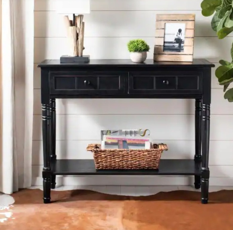 Black console table with drawers