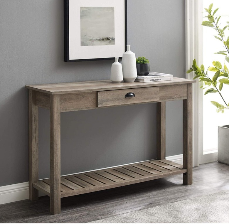 Dark brown wood console table with drawers and shelf
