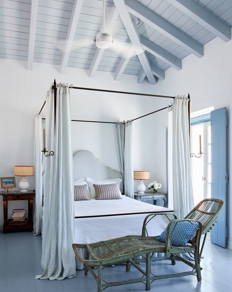 Airy bedroom with blue wood ceiling treatment.