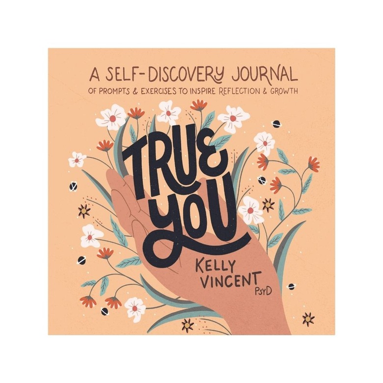 pink journal with text and illustrated hand and flowers