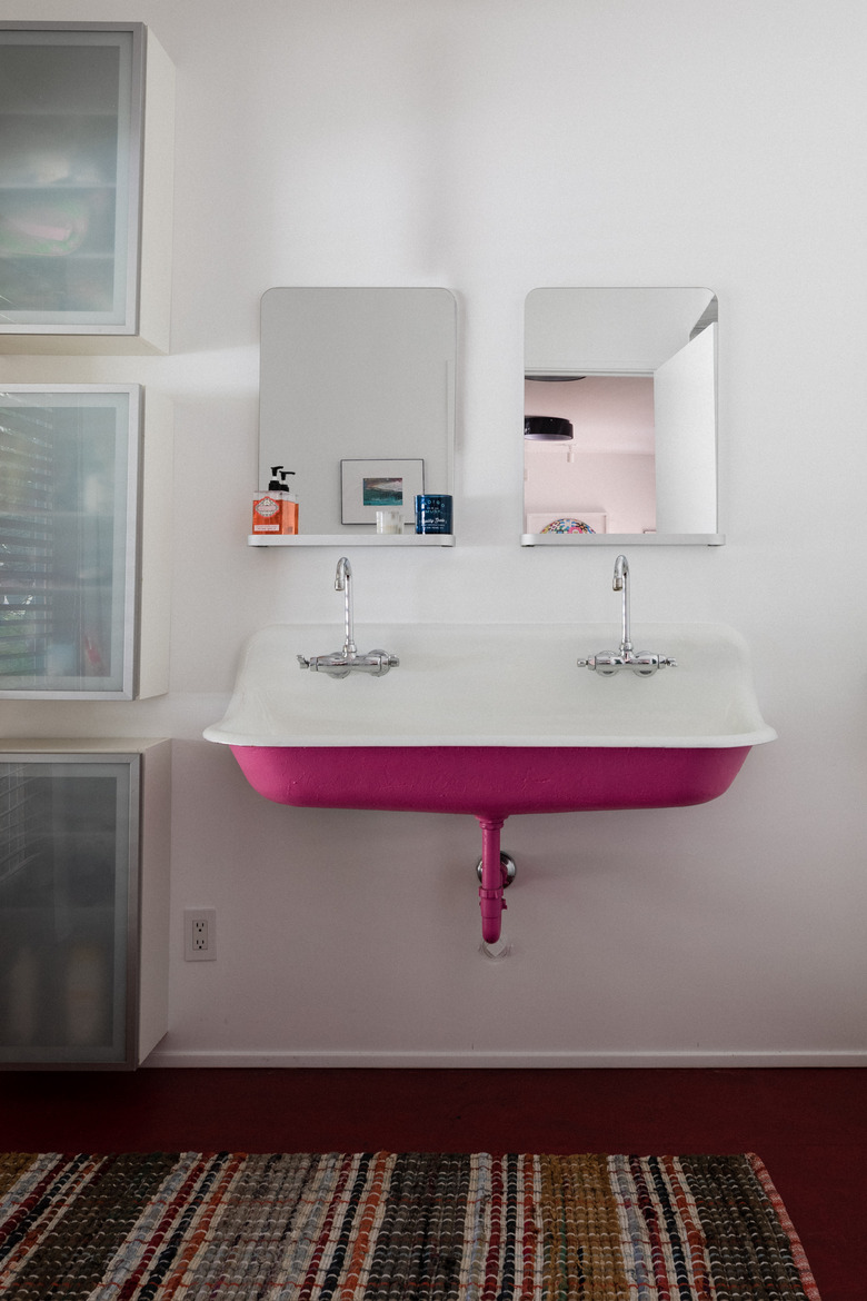 pink cast iron bathroom sink with double faucets