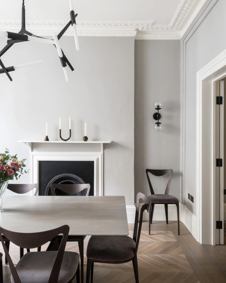 soft gray neutral colors in dining room with fireplace and white mantel