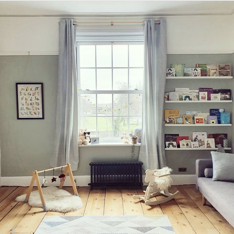 Sage green neutral colors in nursery with linen curtains