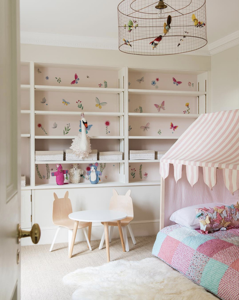 soft pink neutral colors in girl's bedroom with small white table