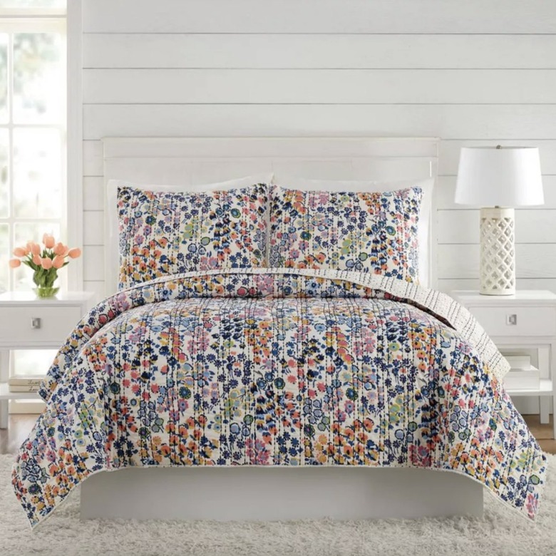 Vera Bradley quilt and pillow shams in a white bedroom