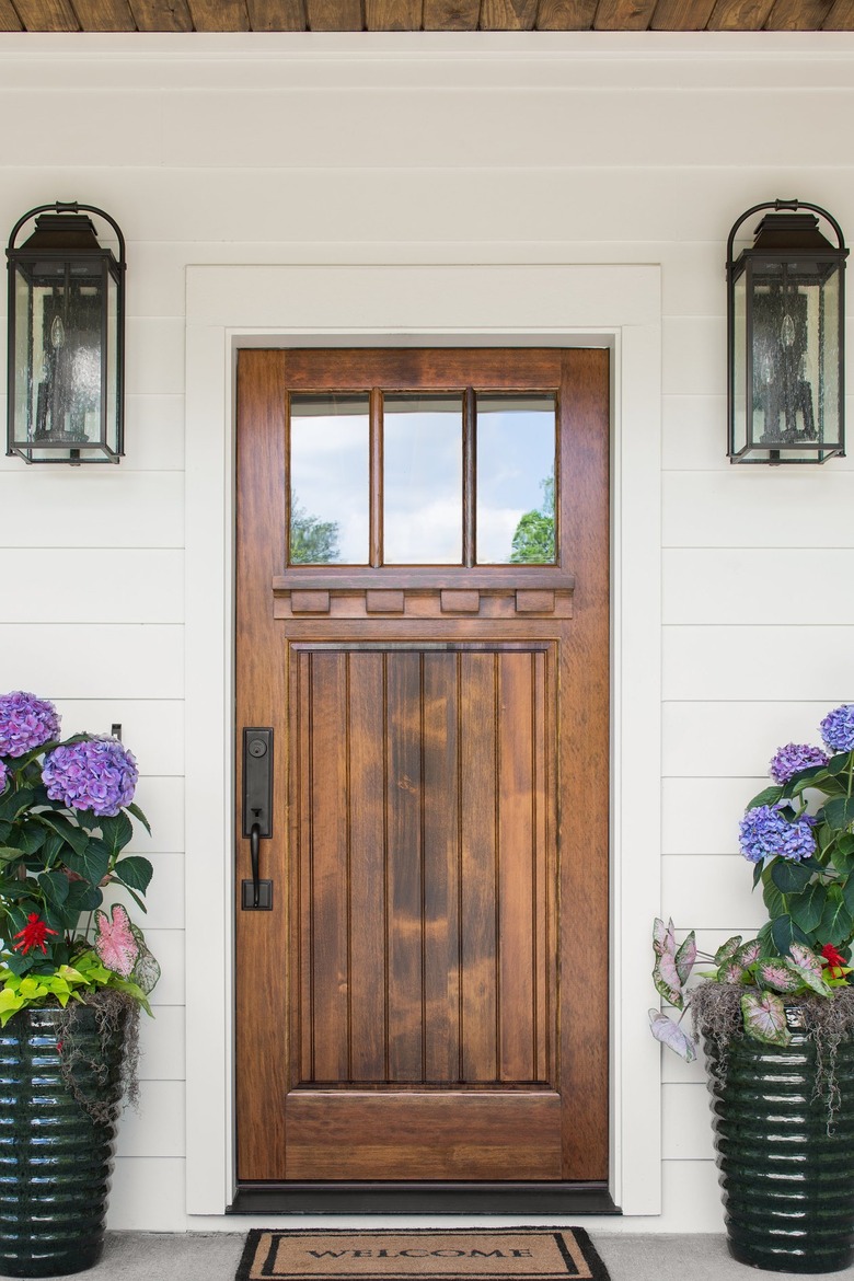 house with white siding and brown wood door