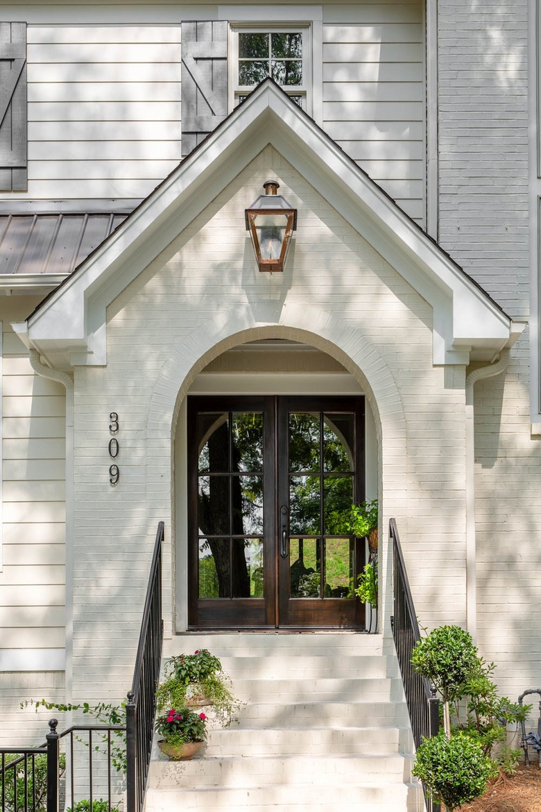 cream-colored house with large lantern over double front doors