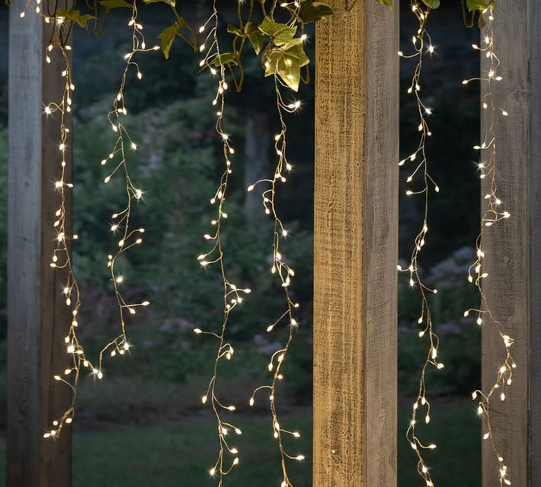 firecracker curtain lights hanging from pergola at night