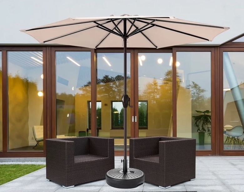 Tan umbrella with chairs