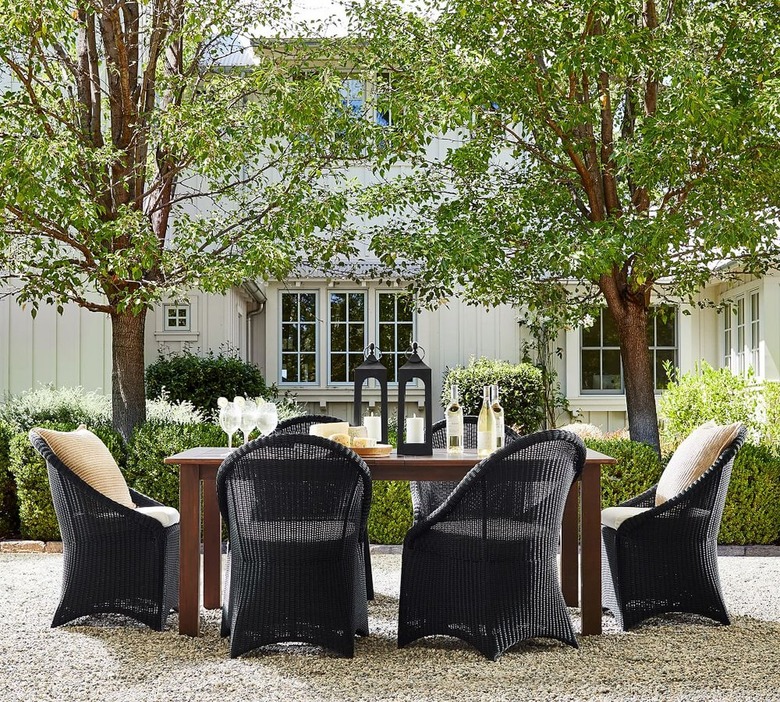 Outdoor dining set with wooden table and black chairs