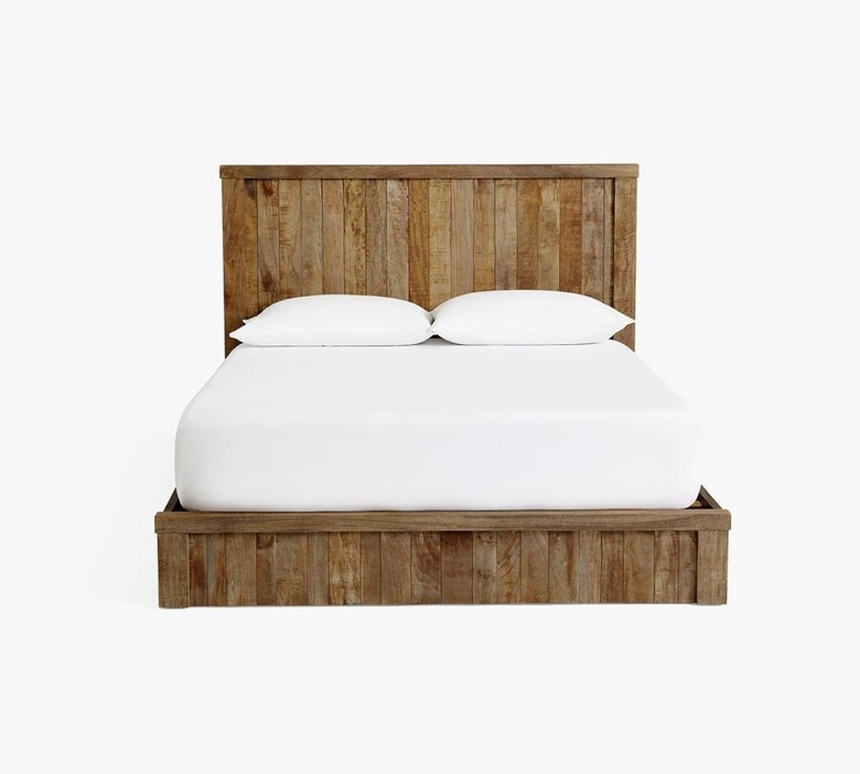 Pottery Barn Keene Platform Bed with white sheet and pillows.