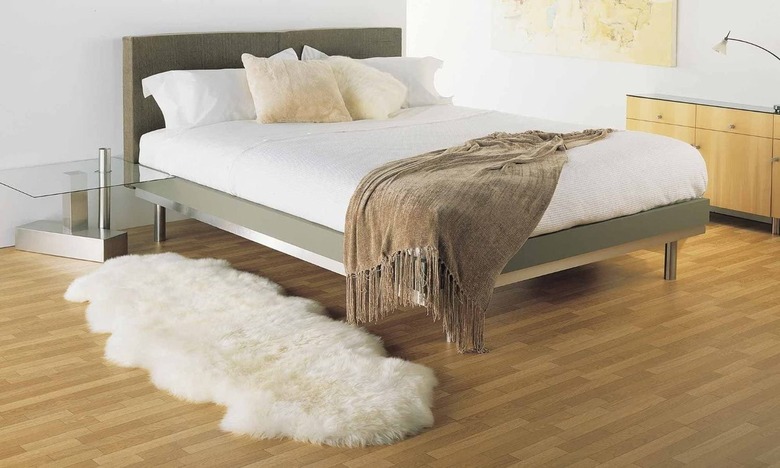 modern bedroom with ivory sheepskin rug and bed