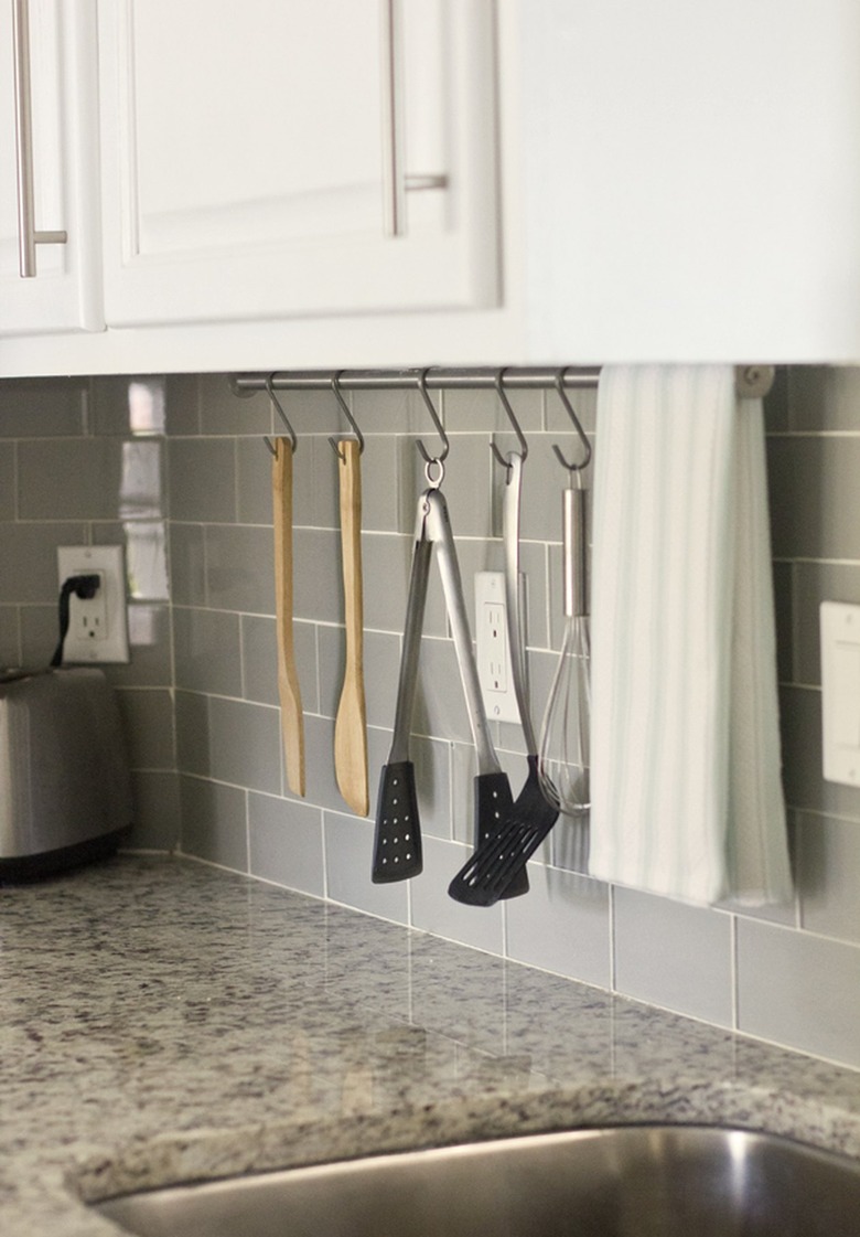 white kitchen countertop in kitchen with gray tile backsplash