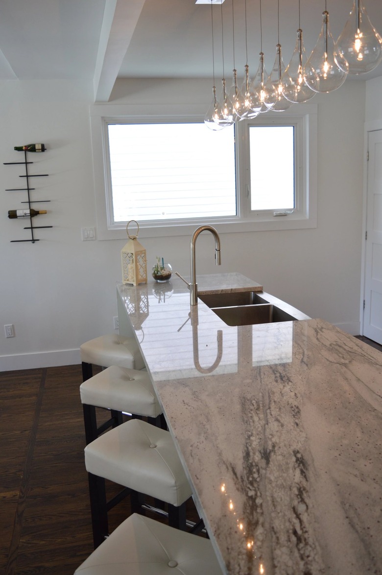 white granite countertop with glossy finish and large light fixture