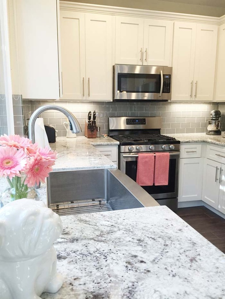 white granite countertop in white and pink kitchen