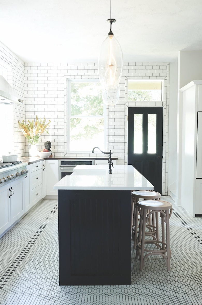 white kitchen with penny round tile flooring