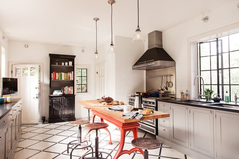 traditional kitchen with black and white grid tile and red industrial island