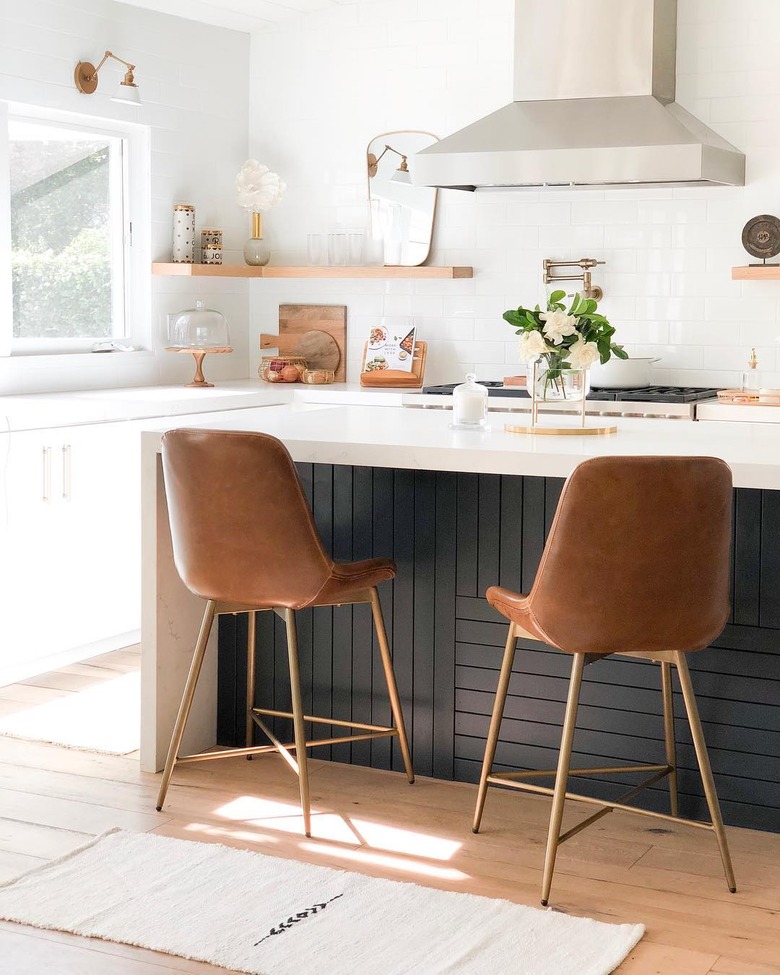 Black kitchen island with white countertops