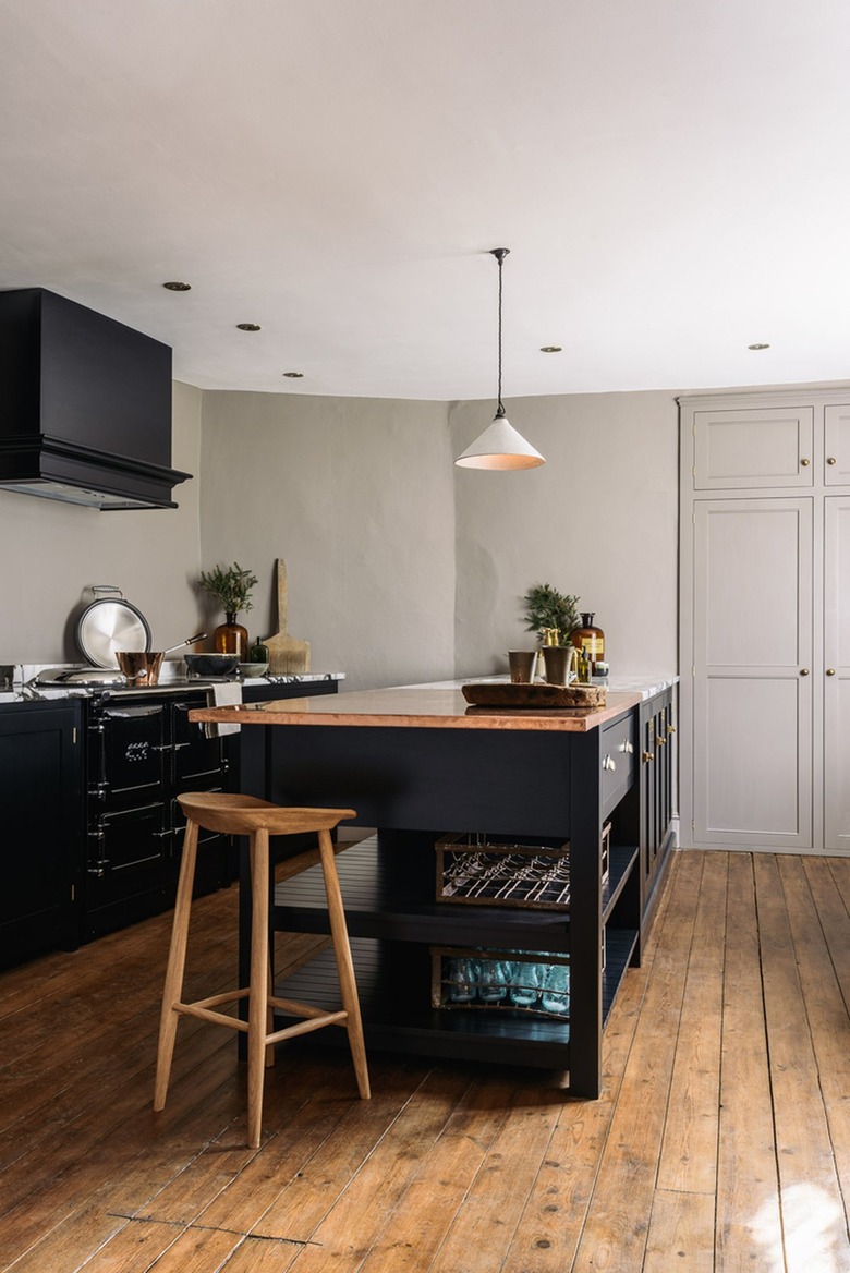 black kitchen island with white quartzite and copper countertop