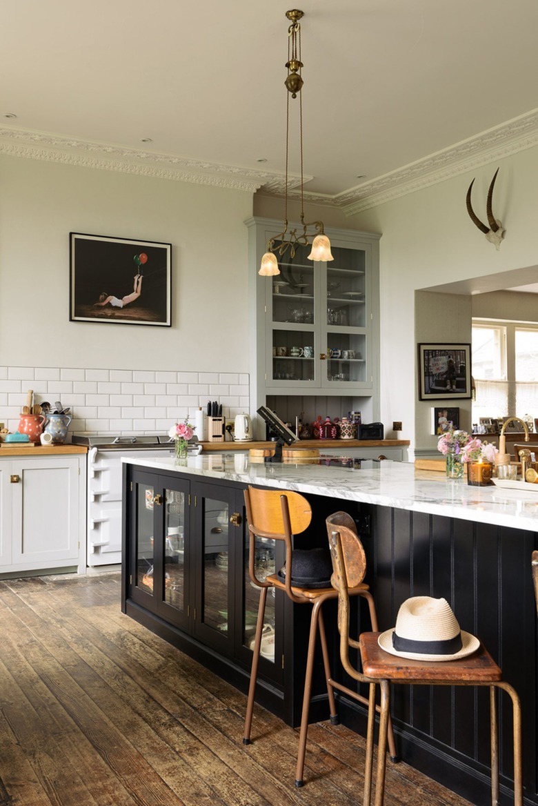 black kitchen island with glass door fronts