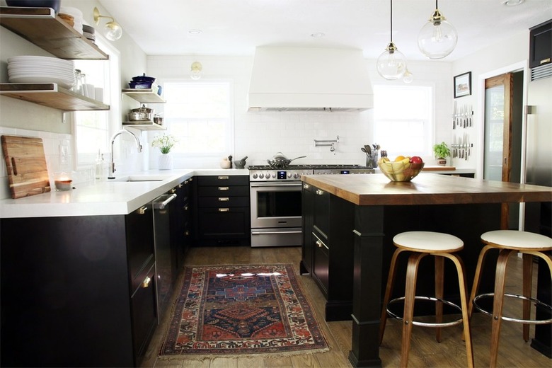 black kitchen island with butcher block counter