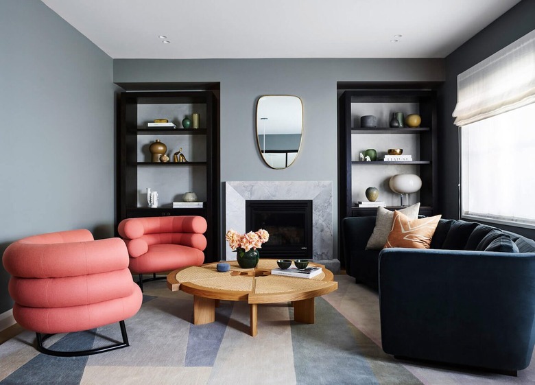 blue living room with coral-colored lounge chairs